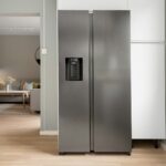 A refrigerator in a kitchen next to a window