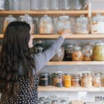 a person holding a jar of food