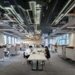 three people collaborating in open office